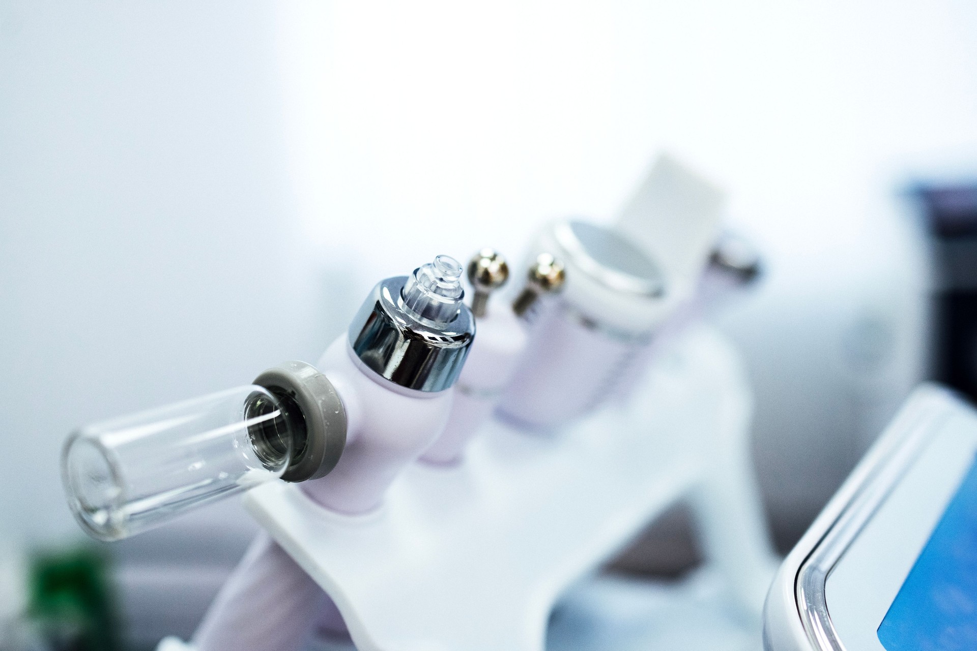 Extreme close up of empty glass bottle for serum on ultrasonic hydromassage beauty apparatus. Alice Water Bubble.