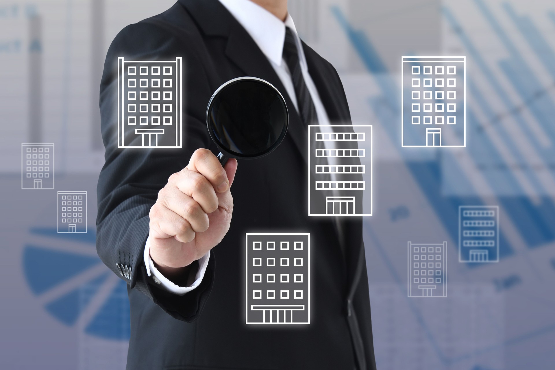 Businessman using a magnifying glass to research a company
