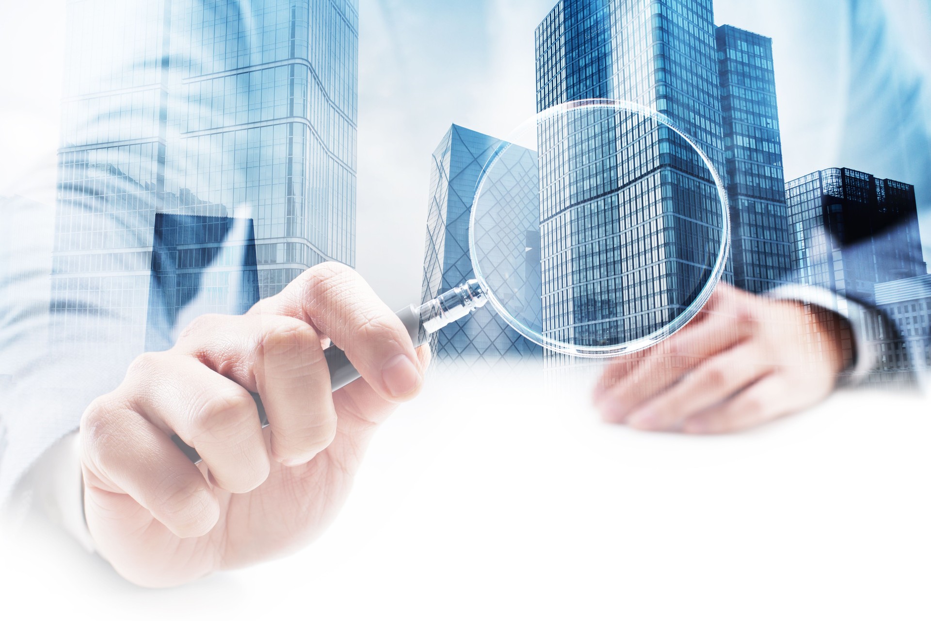 Businessman Holding a Magnifying Glass with Double Exposure Cityscape
